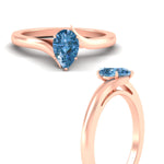 Load image into Gallery viewer, twisted-shank-pear-shaped-vivid-blue-solitaire-engagement-ring-in-rose-gold-fdenr1020pegvblueangle3-nl-rg.jpg